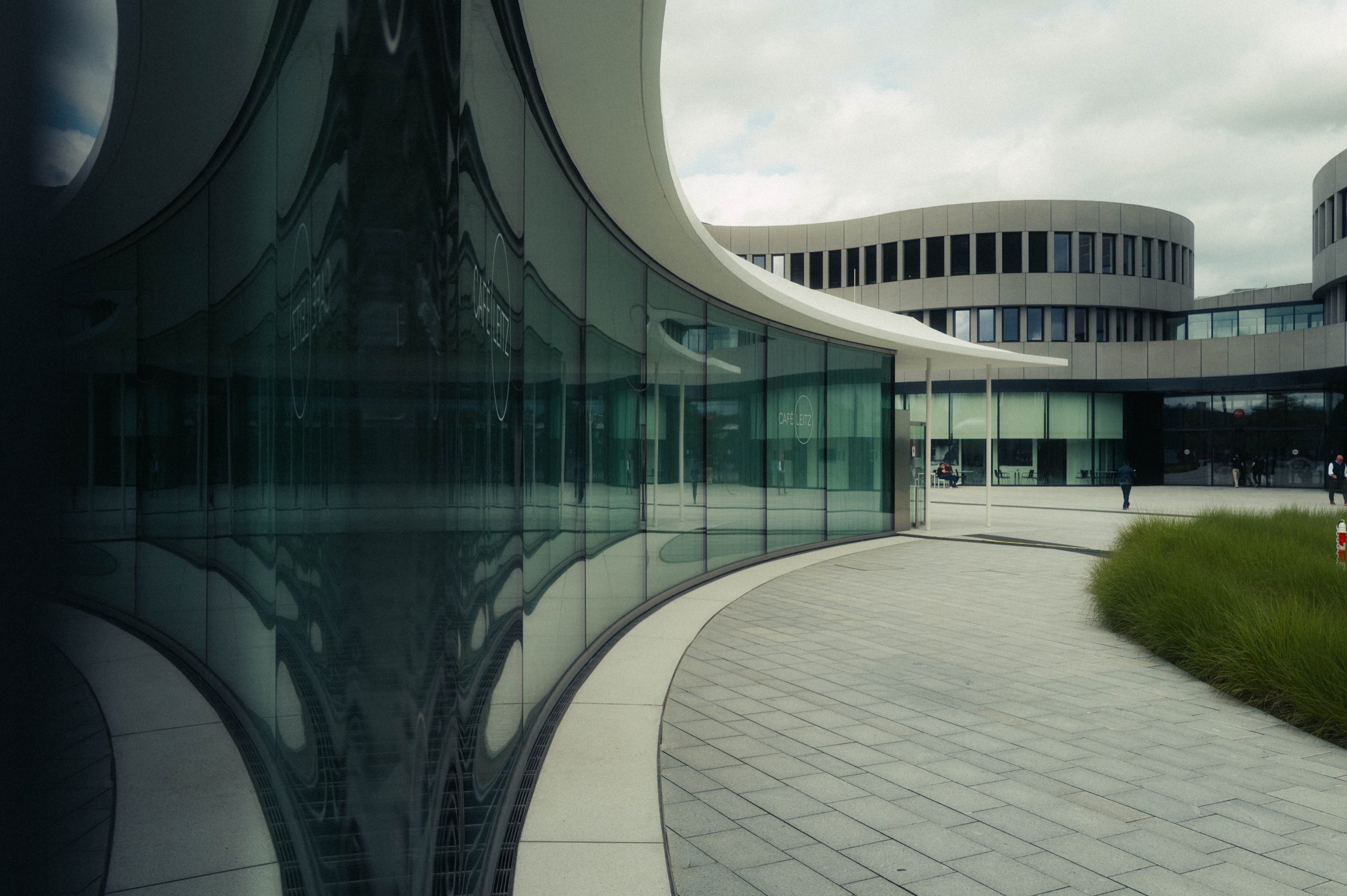 Geschwungene Glasfassade des Leitz-Parks mit Spiegelung