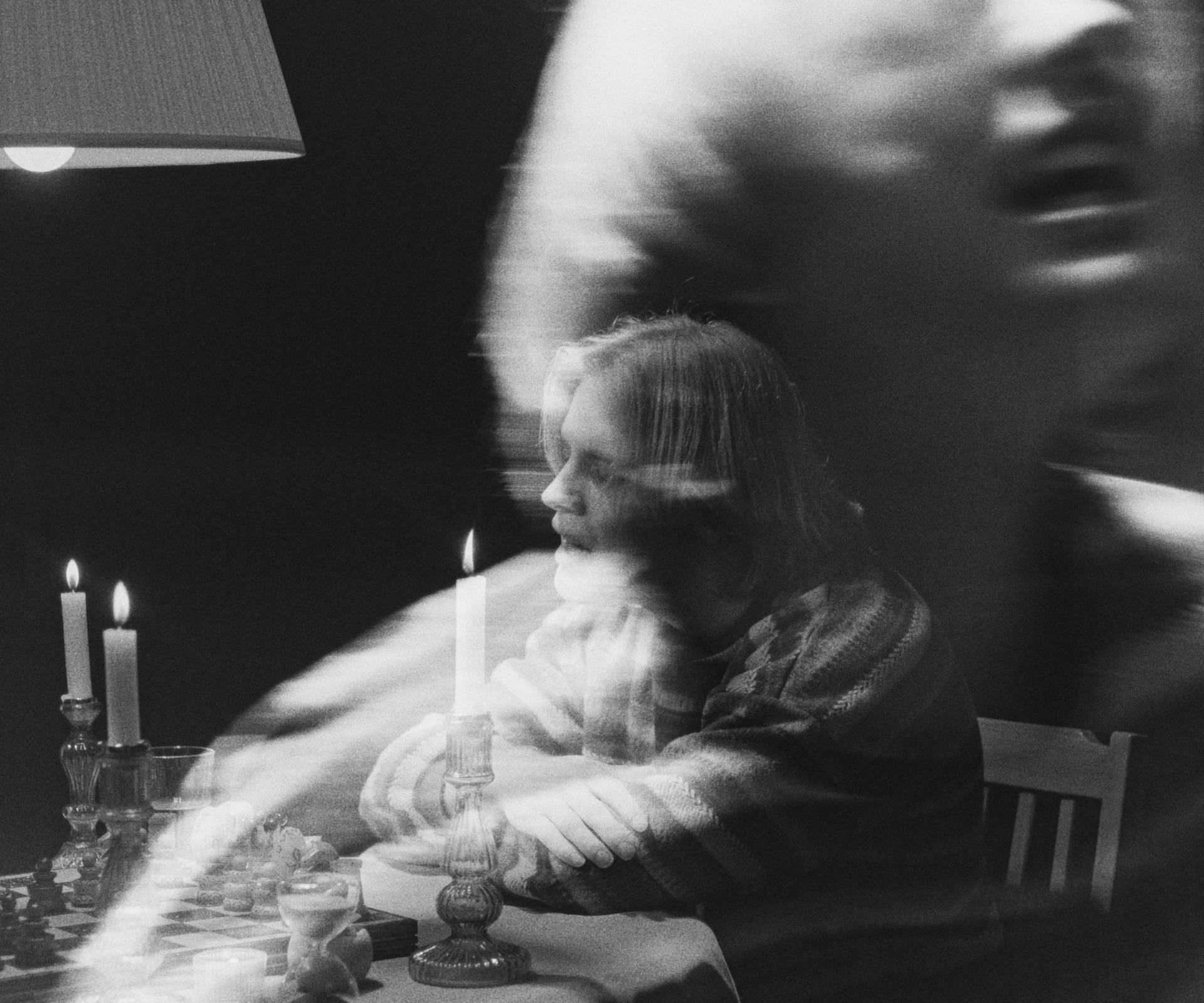 Double exposure: Ivo Martin at the chess table, a blurred face laid over him