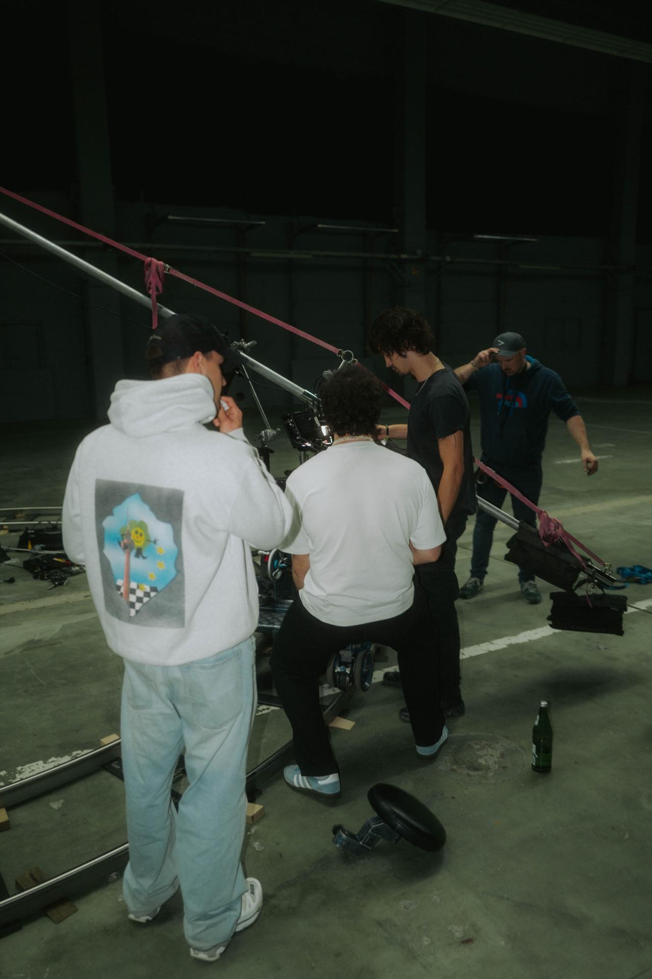 Crew around the camera crane on the dolly tracks in the hall