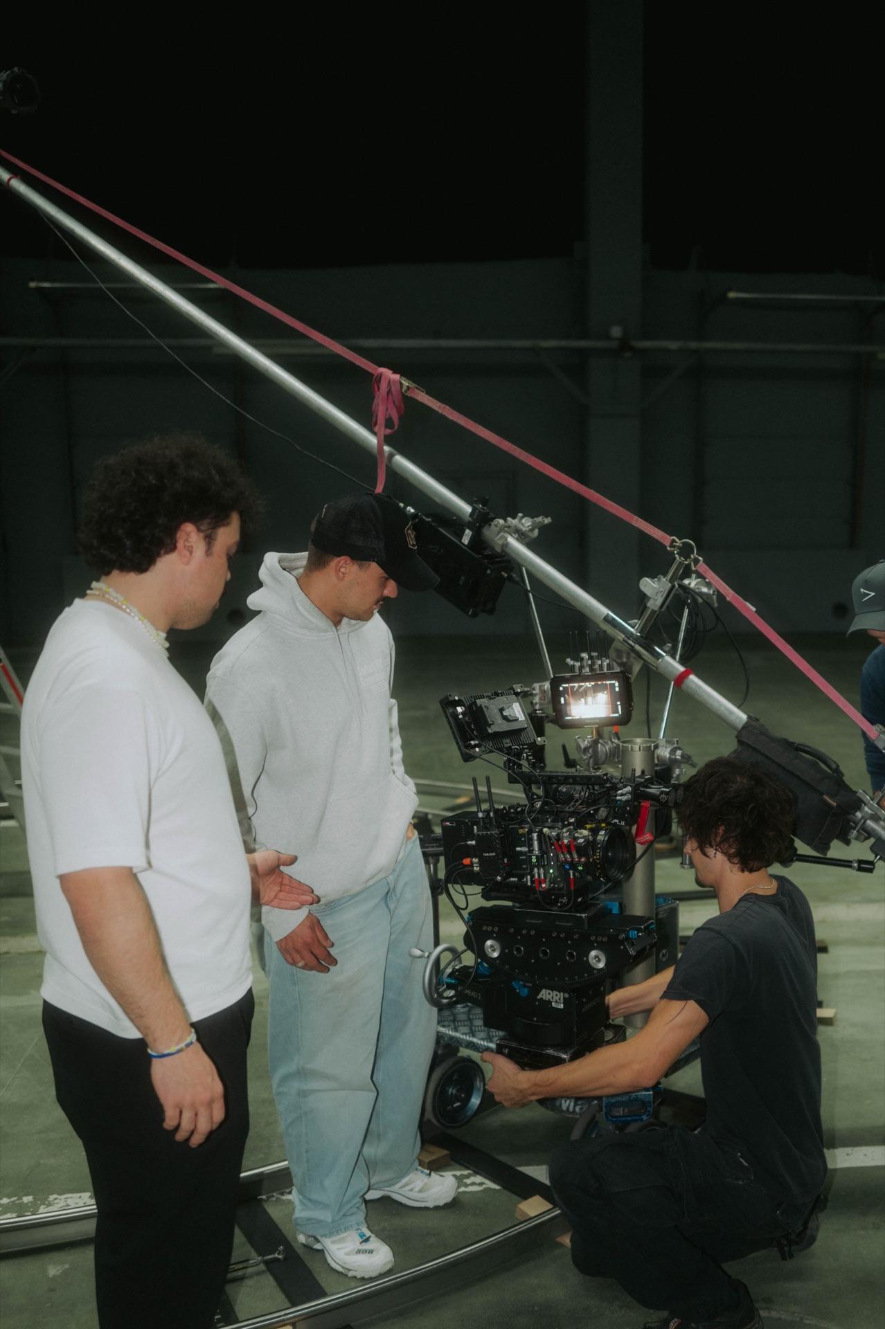 The crew watches as the camera is set up on the dolly