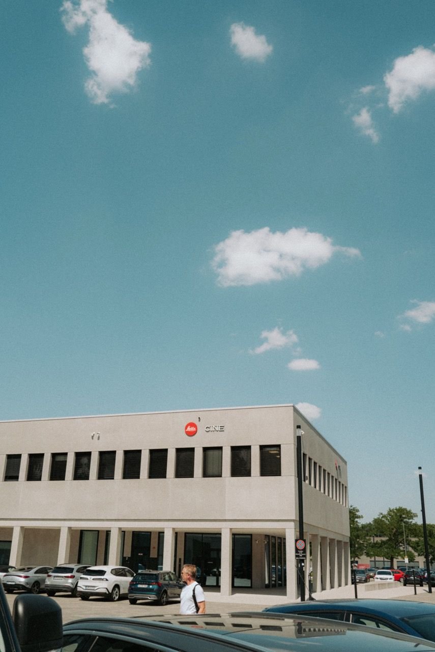 Low building at the Leitz-Park with a red Leica dot and the words Leitz CINE on the facade, blue sky above