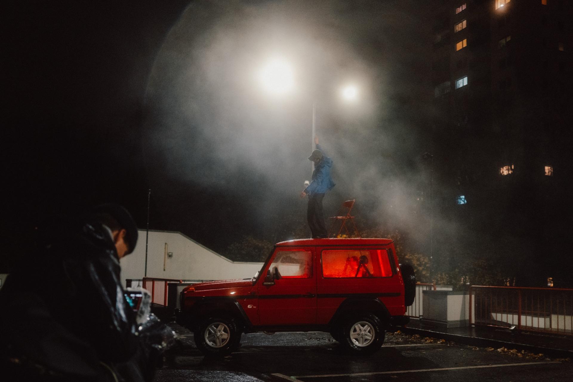 Fireworks over a red pickup truck at night