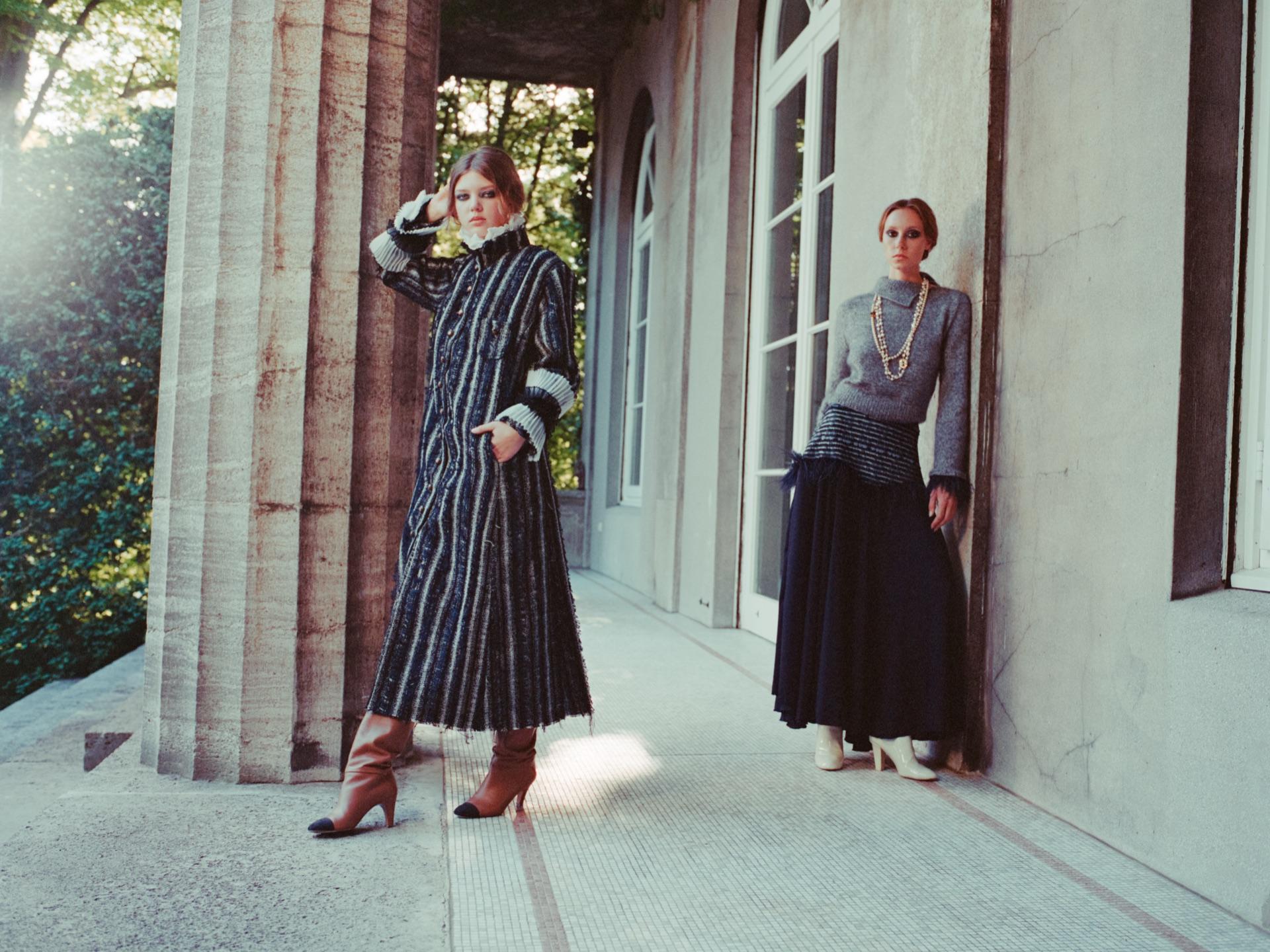 Model in a striped coat in the colonnade of the villa